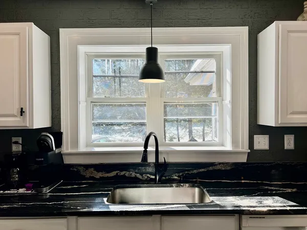 a kitchen with a counter space a sink and cabinets