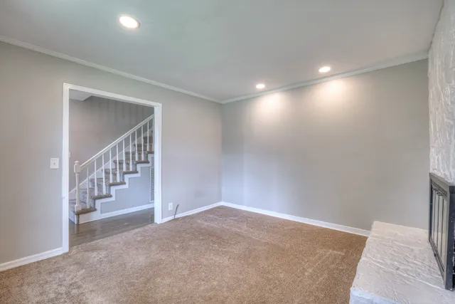 a view of an empty room with stairs