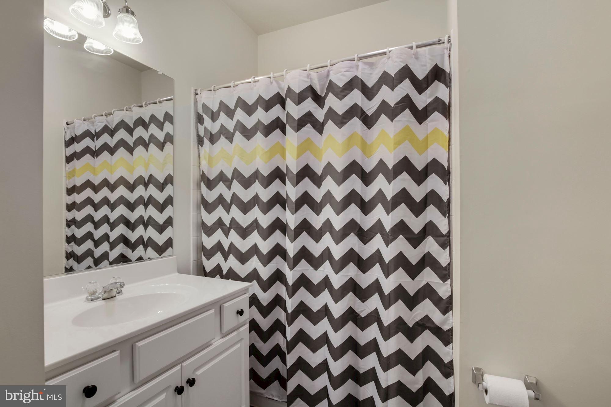 3825 Doc Berlin Drive, Unit 17 Silver Spring, MD 20906 - Photo 25 of 34 a bathroom with a sink and a mirror