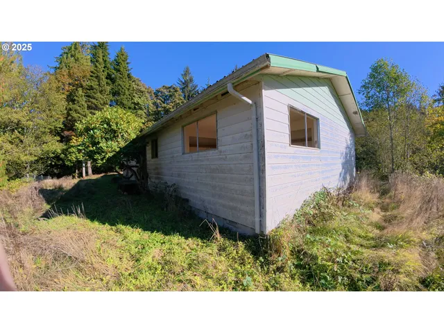 a black and white house with a yard