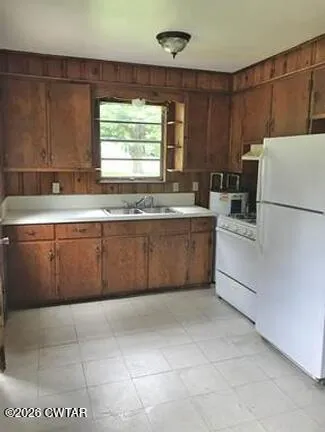 a kitchen with a cabinets and white appliances