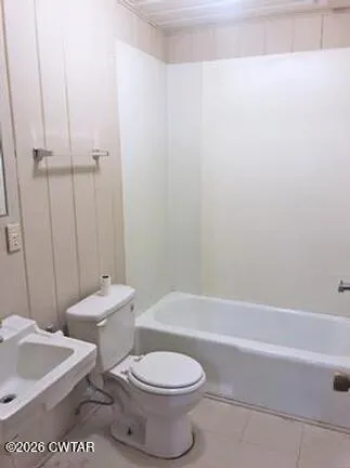 a bathroom with a toilet a sink and bathtub