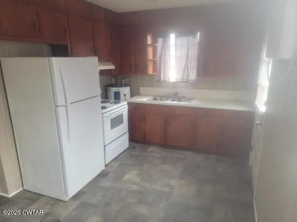 a white refrigerator freezer sitting inside of a kitchen