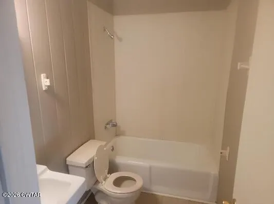 a bathroom with a toilet and bathtub
