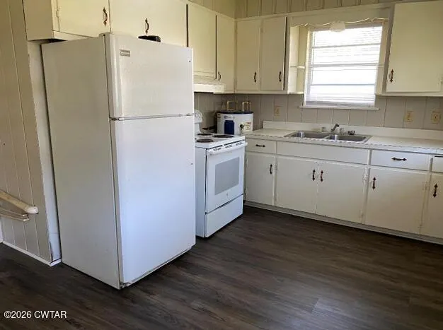 a white refrigerator freezer sitting inside of a kitchen