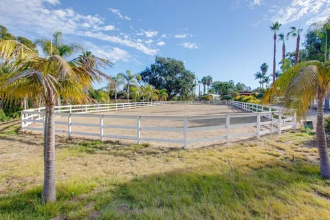 an aerial view of residential houses with outdoor space and swimming pool