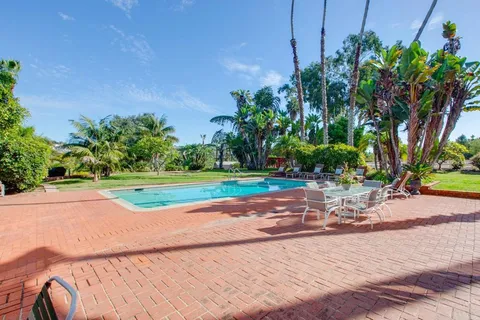 a view of swimming pool with a yard