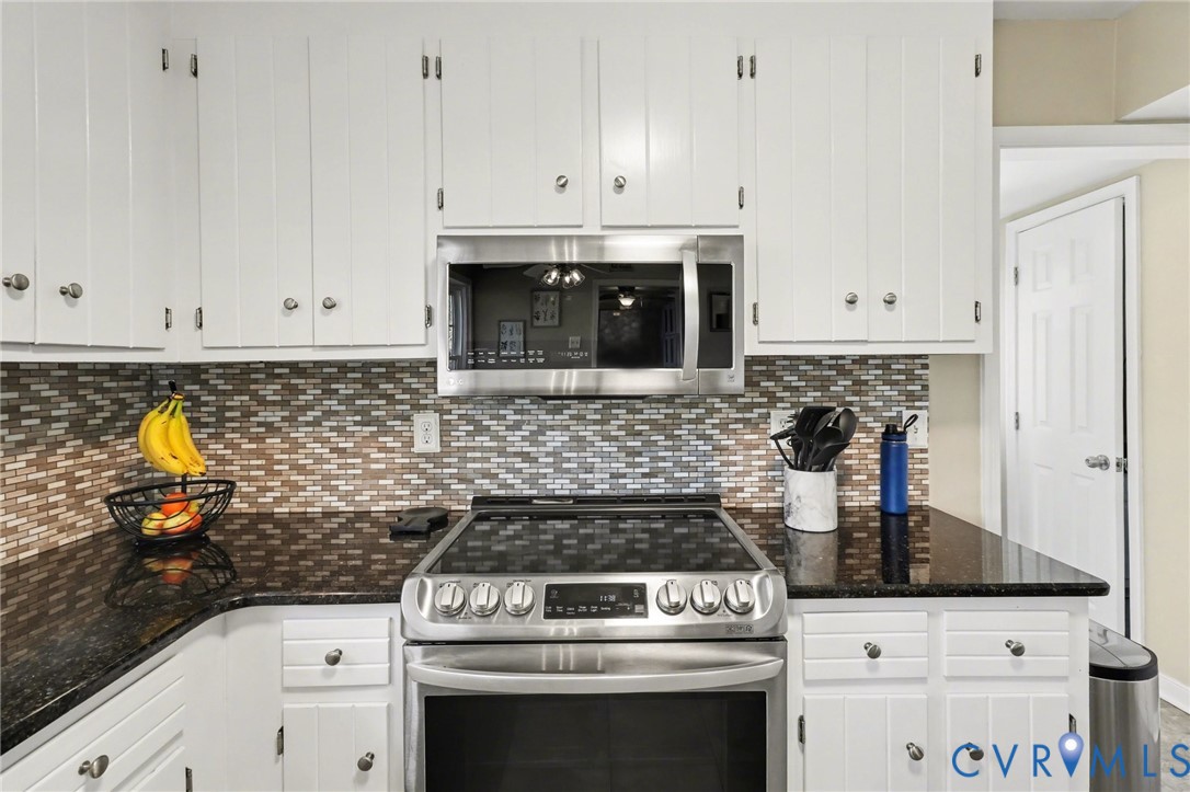 548 Glenmeadow Road Midlothian, VA 23114 - Photo 6 of 31 a kitchen with granite countertop white cabinets and white stove