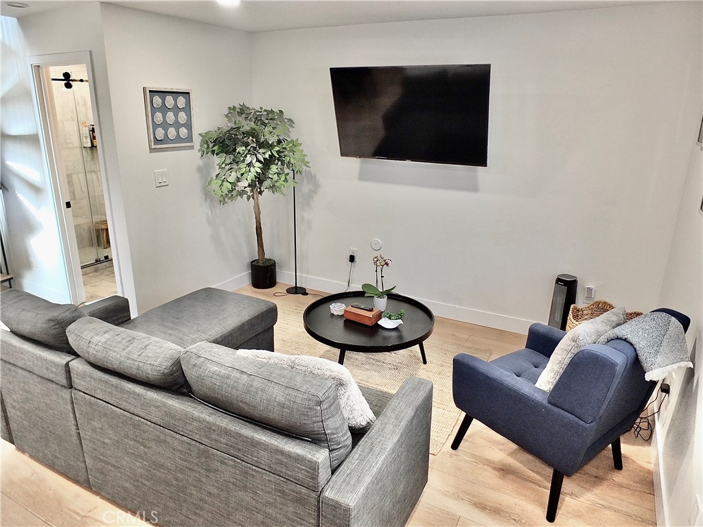 16765 South Pacific Avenue, Unit B' Huntington Beach, CA 90742 - Photo 11 of 45 a living room with furniture and a flat screen tv
