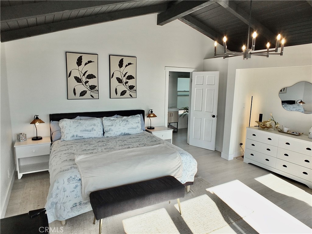 16765 South Pacific Avenue, Unit B' Huntington Beach, CA 90742 - Photo 22 of 45 a bedroom with a bed and lamp