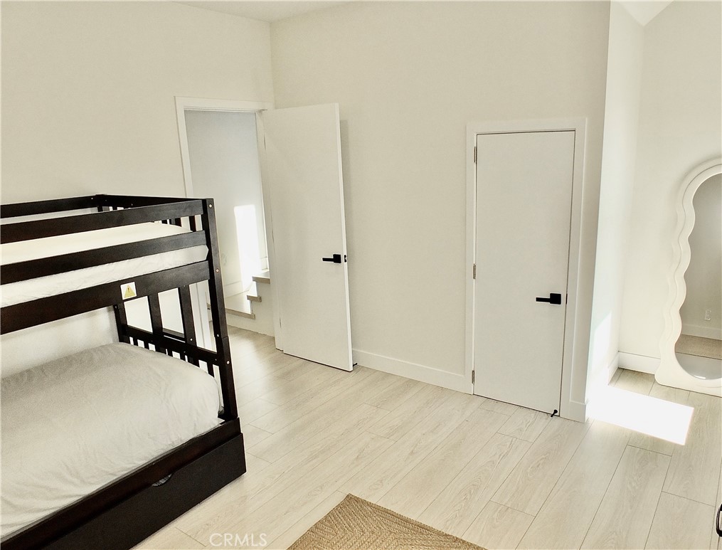 16765 South Pacific Avenue, Unit B' Huntington Beach, CA 90742 - Photo 30 of 45 a view of a hallway with wooden floor and staircase