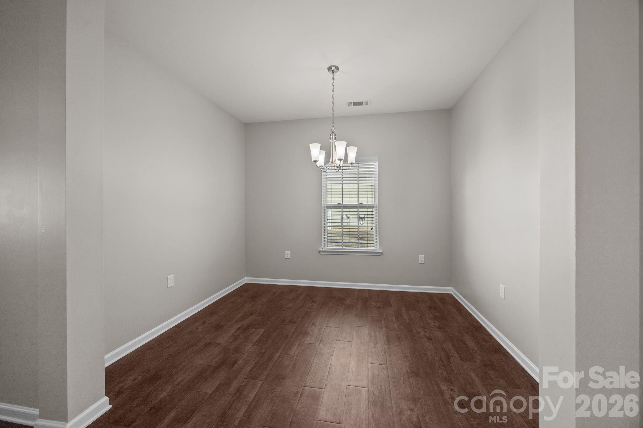 116 Rippling Water Drive Mount Holly, NC 28120 - Photo 11 of 48 wooden floor in an empty room with a window