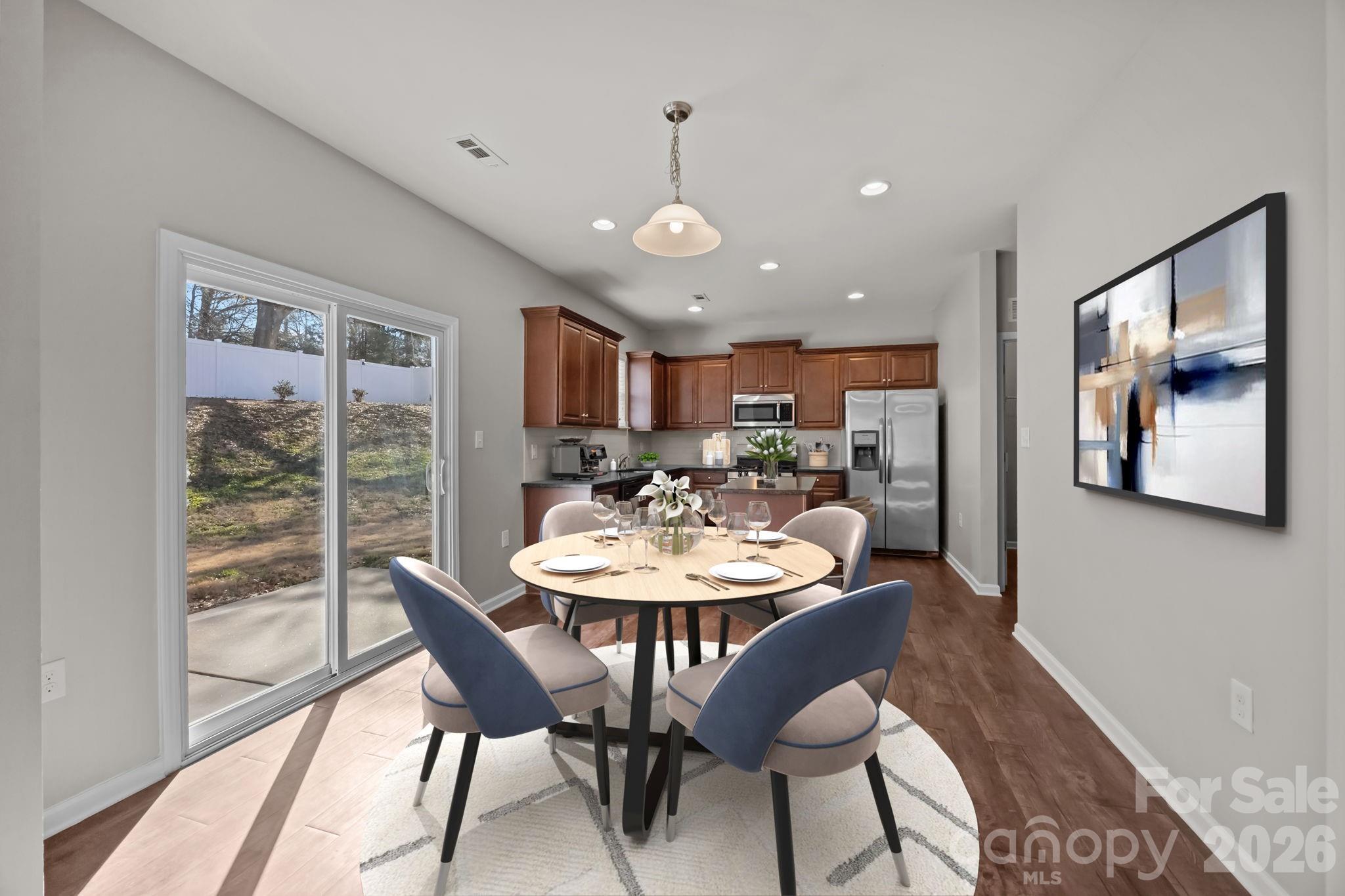 116 Rippling Water Drive Mount Holly, NC 28120 - Photo 12 of 48 a view of a dining room with furniture window and wooden floor