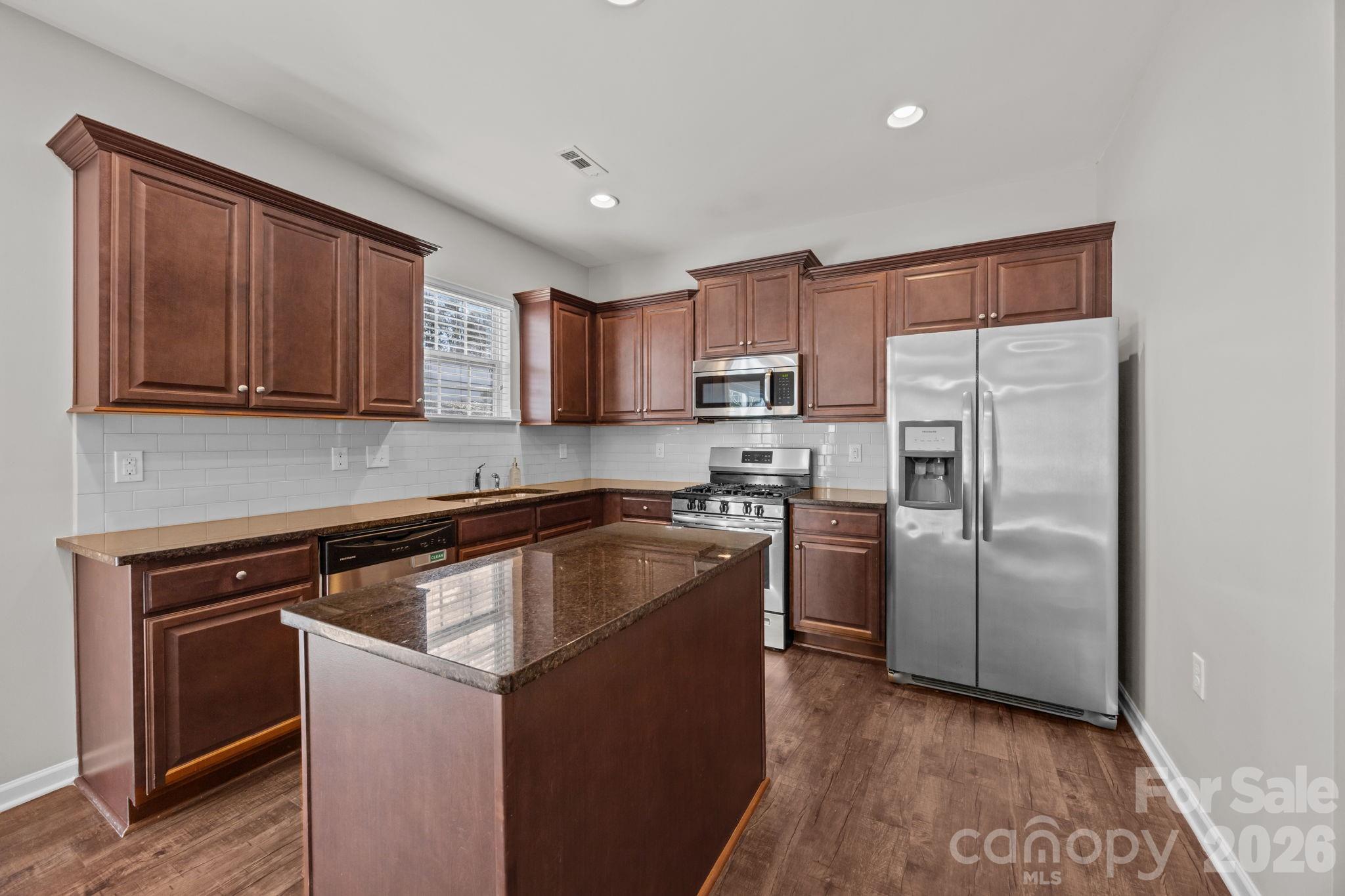 116 Rippling Water Drive Mount Holly, NC 28120 - Photo 15 of 48 a kitchen with a refrigerator sink and microwave