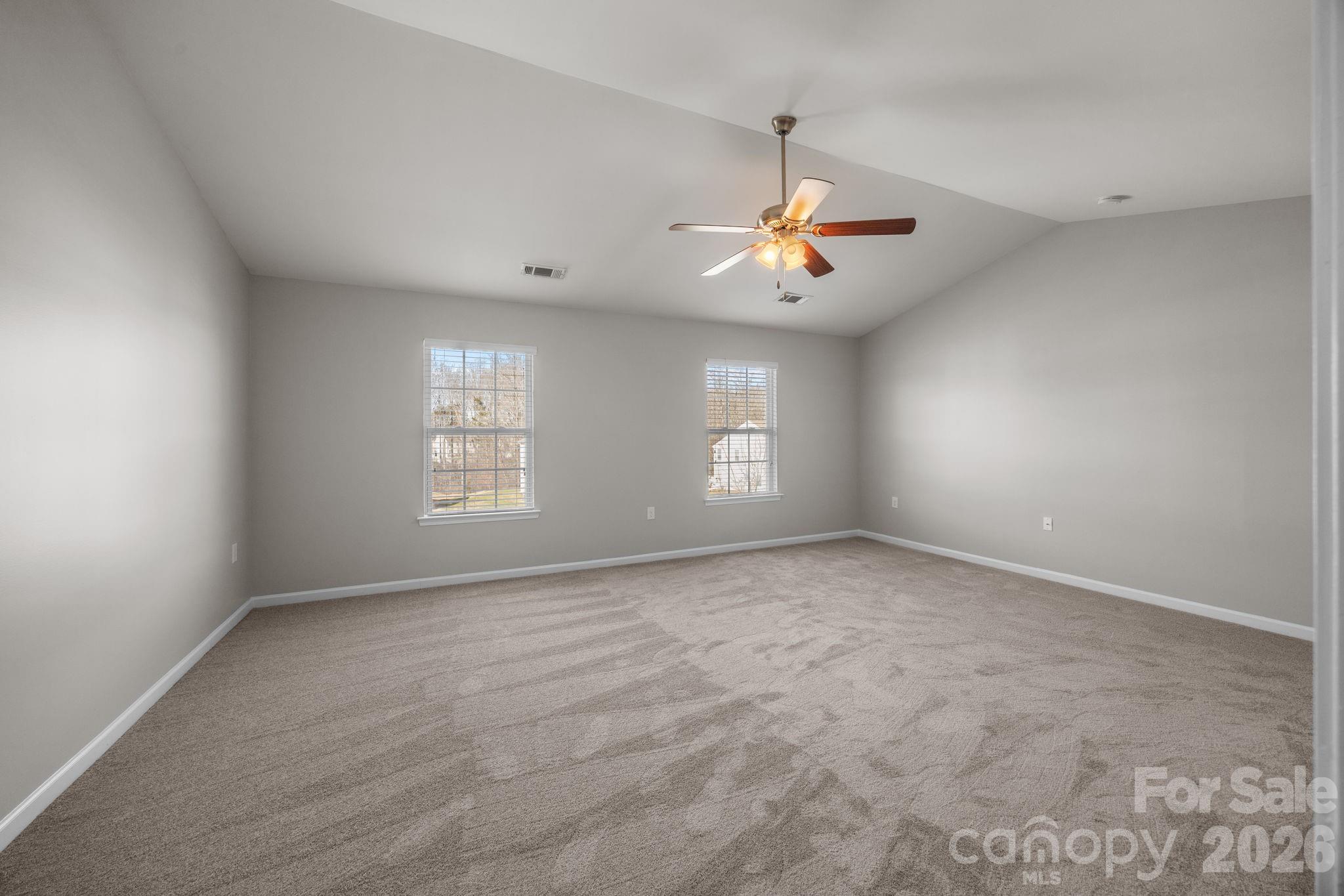 116 Rippling Water Drive Mount Holly, NC 28120 - Photo 26 of 48 an empty room with windows and ceiling fan