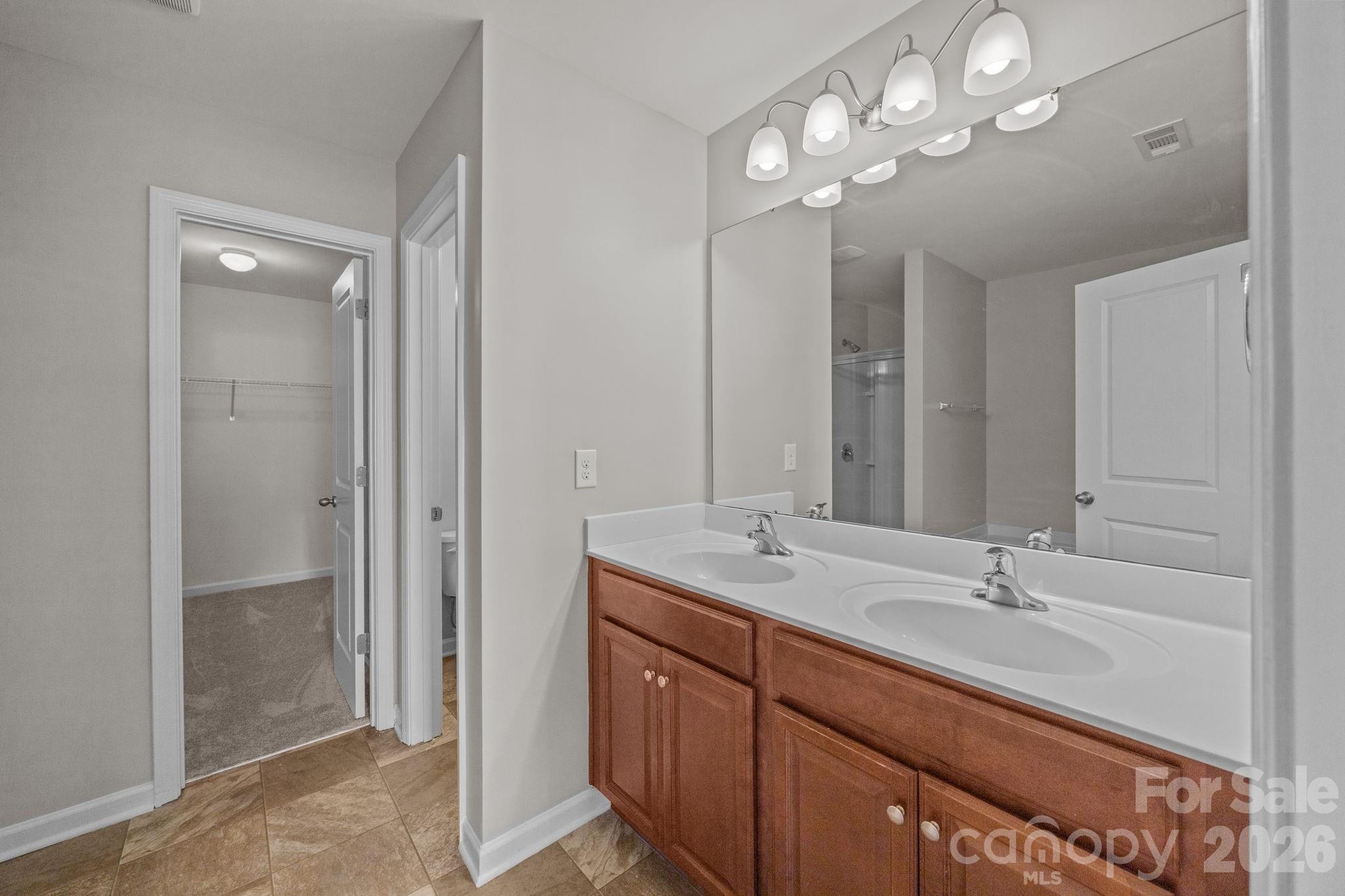 116 Rippling Water Drive Mount Holly, NC 28120 - Photo 27 of 48 a bathroom with a sink double vanity and a mirror