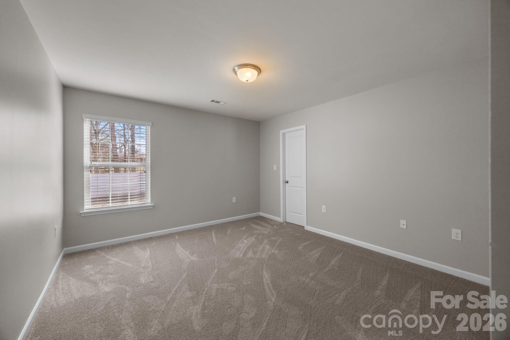 116 Rippling Water Drive Mount Holly, NC 28120 - Photo 32 of 48 a view of an empty room with a window