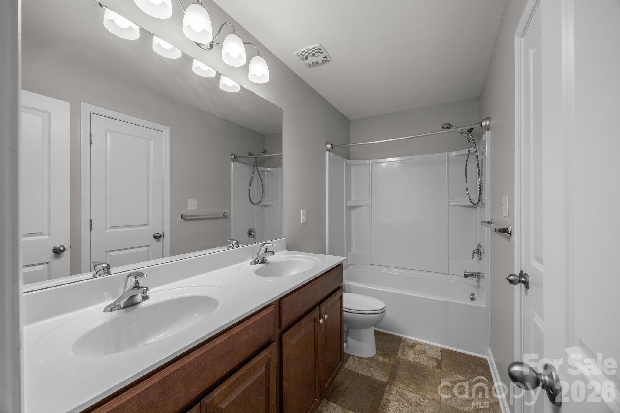 116 Rippling Water Drive Mount Holly, NC 28120 - Photo 34 of 48 a bathroom with a tub a sink and mirror
