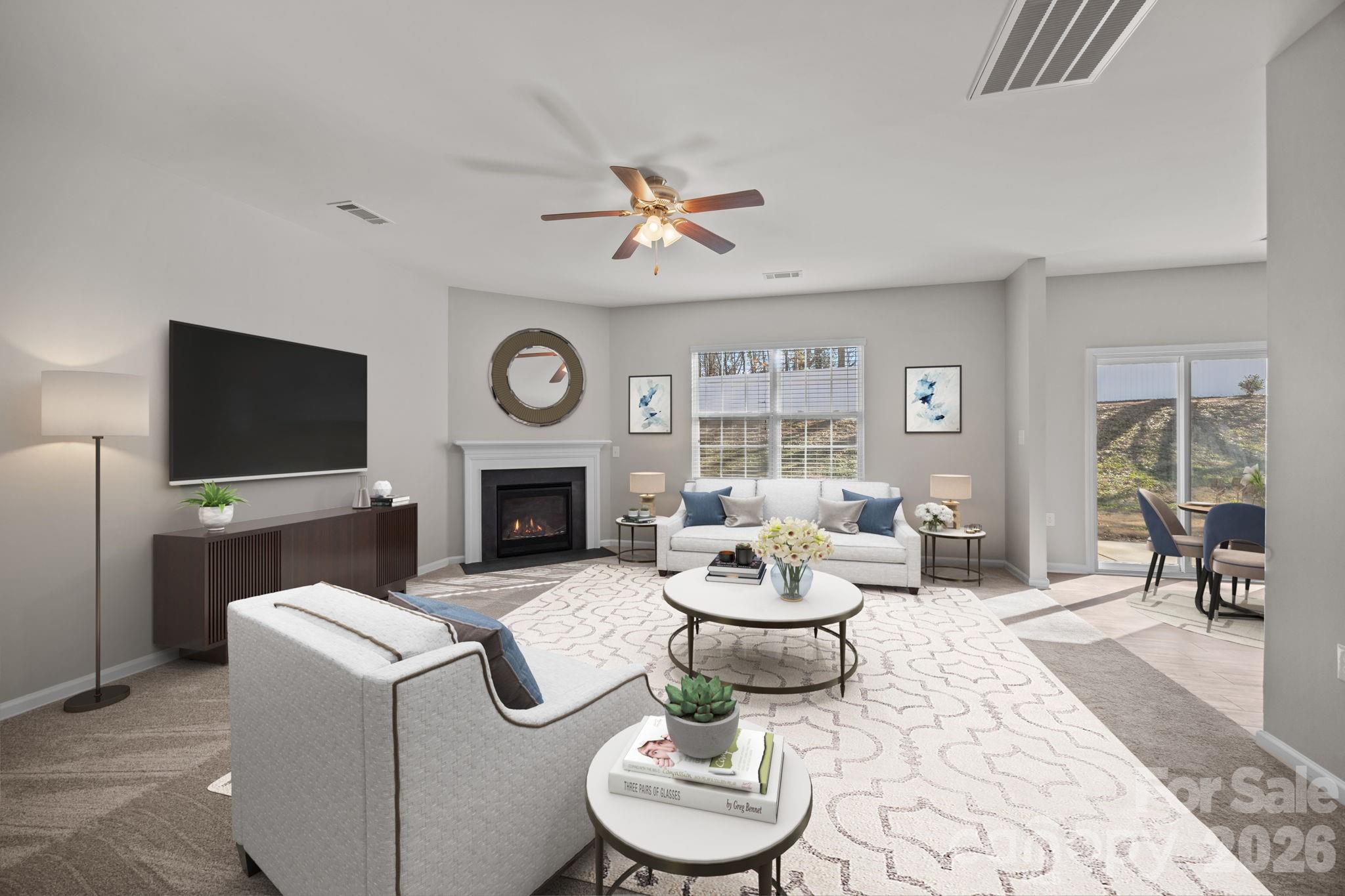 116 Rippling Water Drive Mount Holly, NC 28120 - Photo 6 of 48 a living room with furniture a fireplace and a flat screen tv