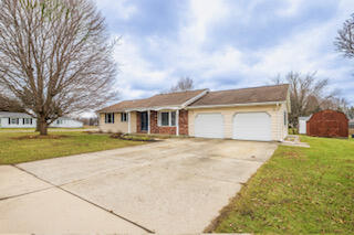 a front view of house with yard and trees
