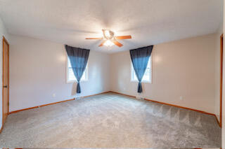 601 Post Street Wanatah, IN 46390 - Photo 19 of 37 a view of an empty room with chandelier fan and a window