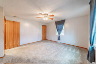 601 Post Street Wanatah, IN 46390 - Photo 21 of 37 an empty room with a ceiling fan and a window