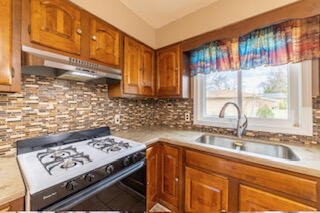 601 Post Street Wanatah, IN 46390 - Photo 25 of 37 a kitchen with a stove a sink and a microwave