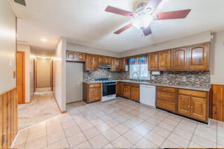 601 Post Street Wanatah, IN 46390 - Photo 28 of 37 a large kitchen with stainless steel appliances kitchen island granite countertop a refrigerator a stove a sink and dishwasher