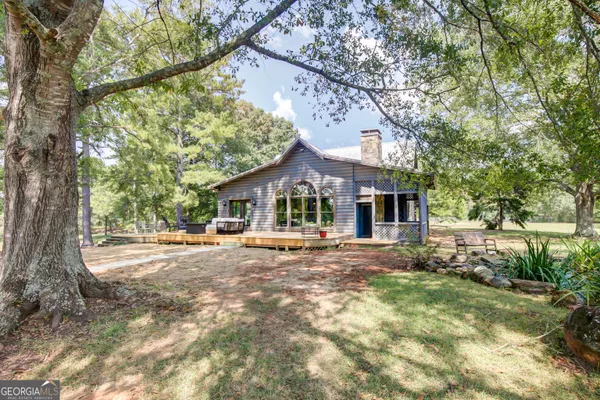 a room with stainless steel appliances kitchen island granite countertop a refrigerator and a stove