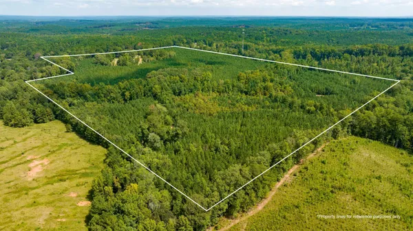 a space with stainless steel appliances kitchen island granite countertop a refrigerator and a stove