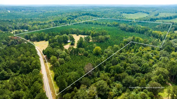 a view of a kitchen with stainless steel appliances granite countertop a sink and wooden cabinets