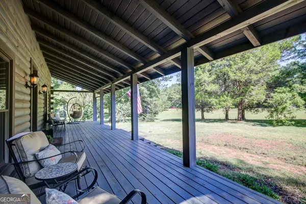 a view of a dining room with furniture large windows and wooden floor