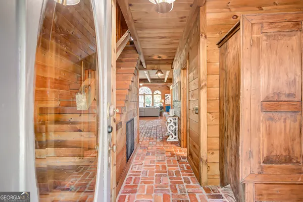 a living room with furniture a fireplace and a large window