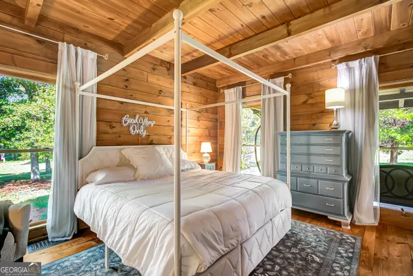a bedroom with a large bed and a window