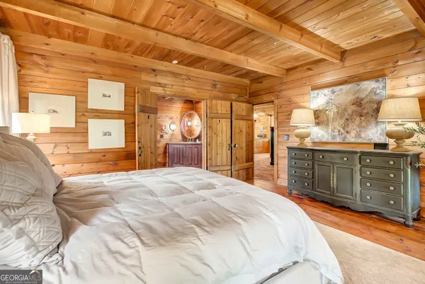 a view of a house with a yard and large tree