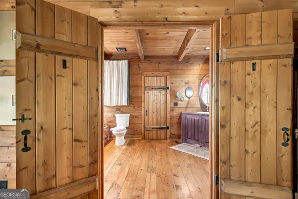 a view of a house with a yard and large trees