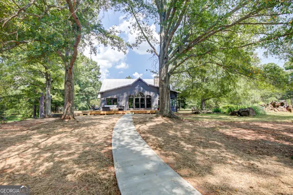 a porch with wooden floor outdoor seating and yard