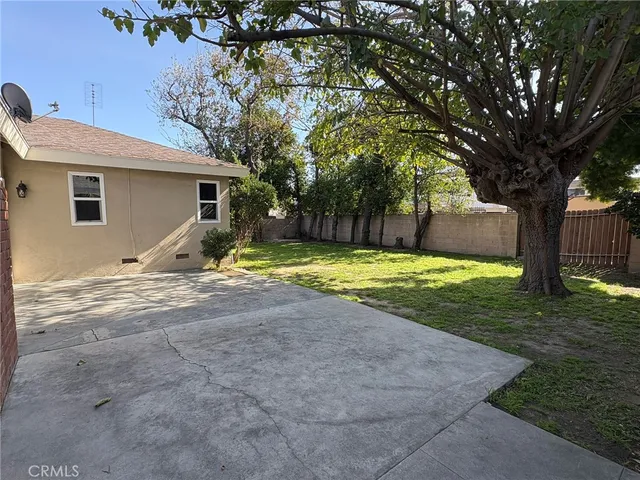 a backyard of a house with yard and outdoor seating