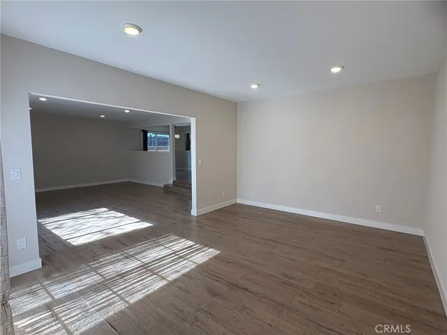 a view of room with wooden floor and rug