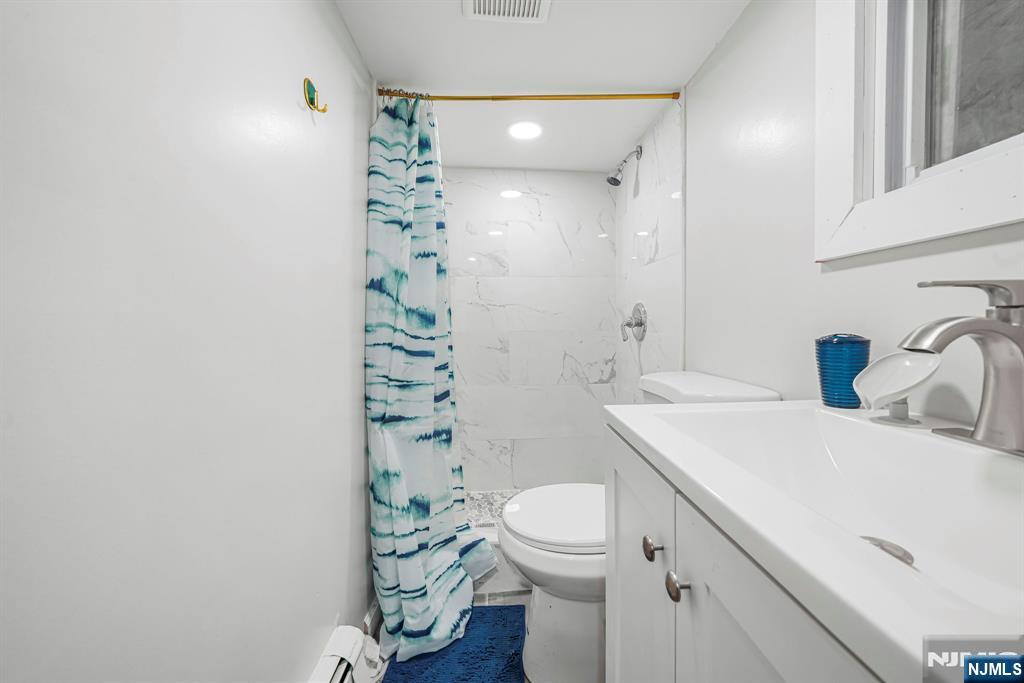 418 South 10th Street Newark, NJ 07103 - Photo 11 of 20 a bathroom with a sink a toilet and shower