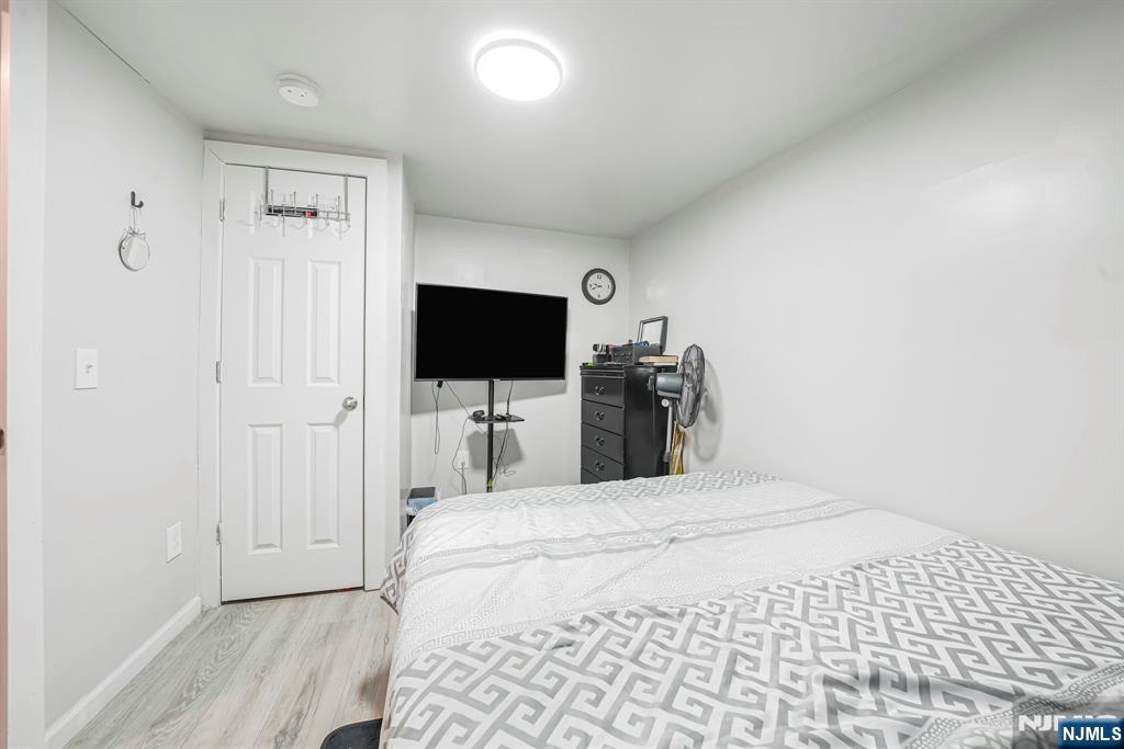 418 South 10th Street Newark, NJ 07103 - Photo 18 of 20 a bedroom with a bed and a flat screen tv