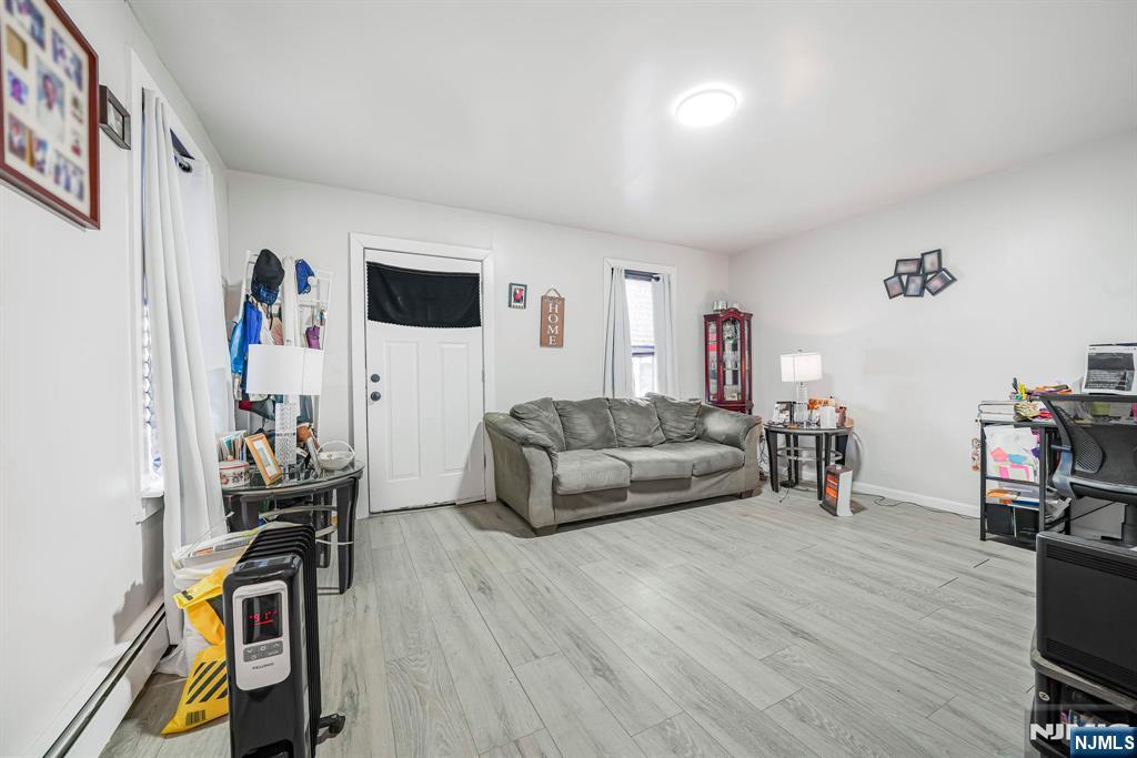 418 South 10th Street Newark, NJ 07103 - Photo 7 of 20 a living room with furniture and a flat screen tv
