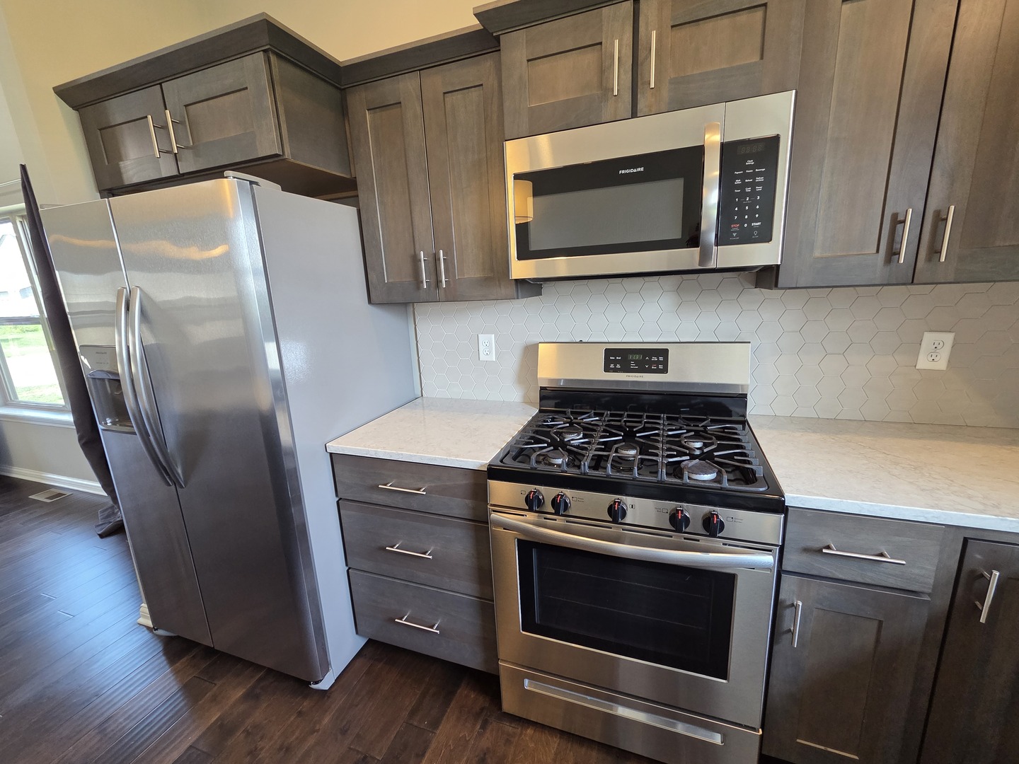 1036 Stags Leap Road Normal, IL 61761 - Photo 11 of 43 a kitchen with granite countertop a stove microwave and refrigerator