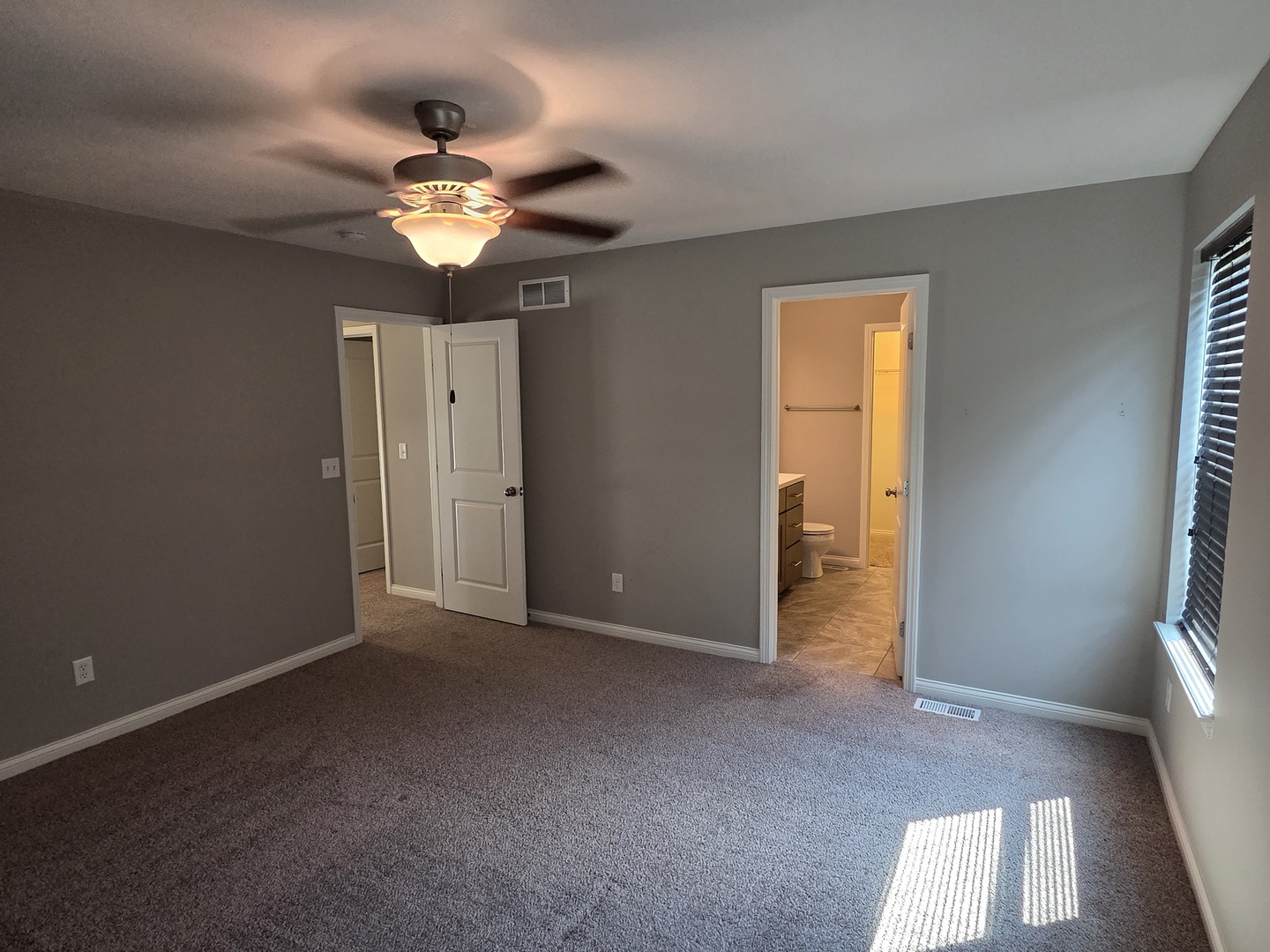 1036 Stags Leap Road Normal, IL 61761 - Photo 17 of 43 a view of a livingroom with a ceiling fan and window