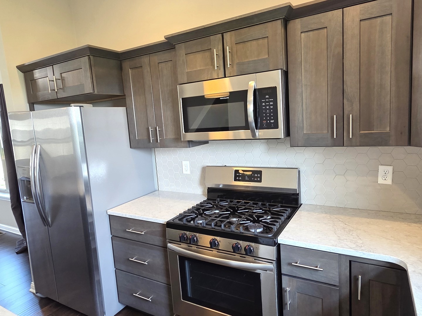 1036 Stags Leap Road Normal, IL 61761 - Photo 5 of 43 a kitchen with stainless steel appliances wooden cabinets and a stove top oven