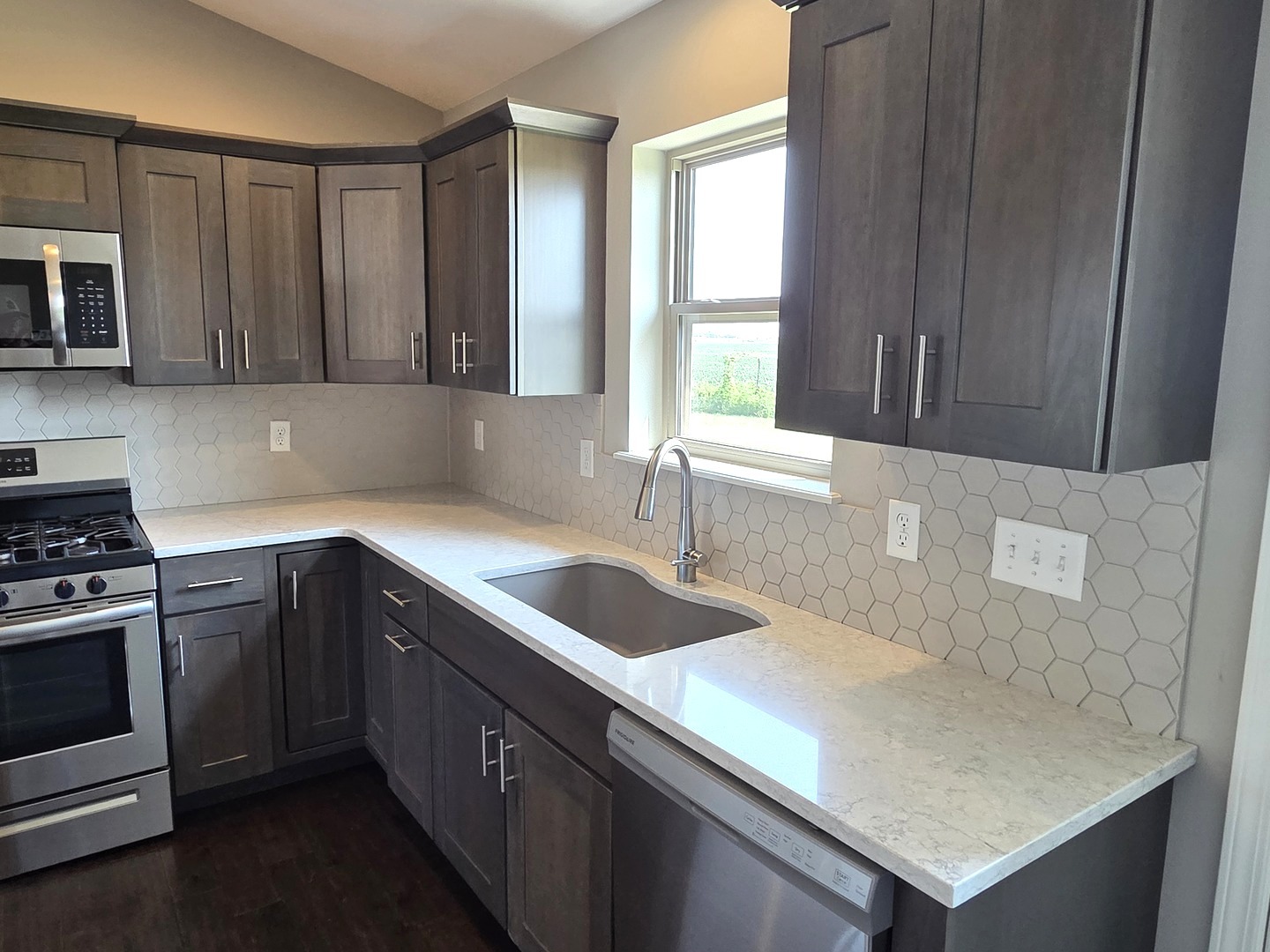 1036 Stags Leap Road Normal, IL 61761 - Photo 6 of 43 a kitchen with granite countertop a sink a stove and cabinets