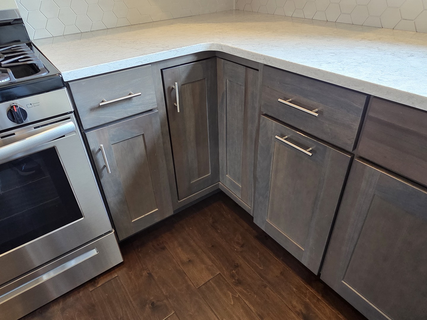 1036 Stags Leap Road Normal, IL 61761 - Photo 7 of 43 a view of an empty room with wooden floor and a kitchen