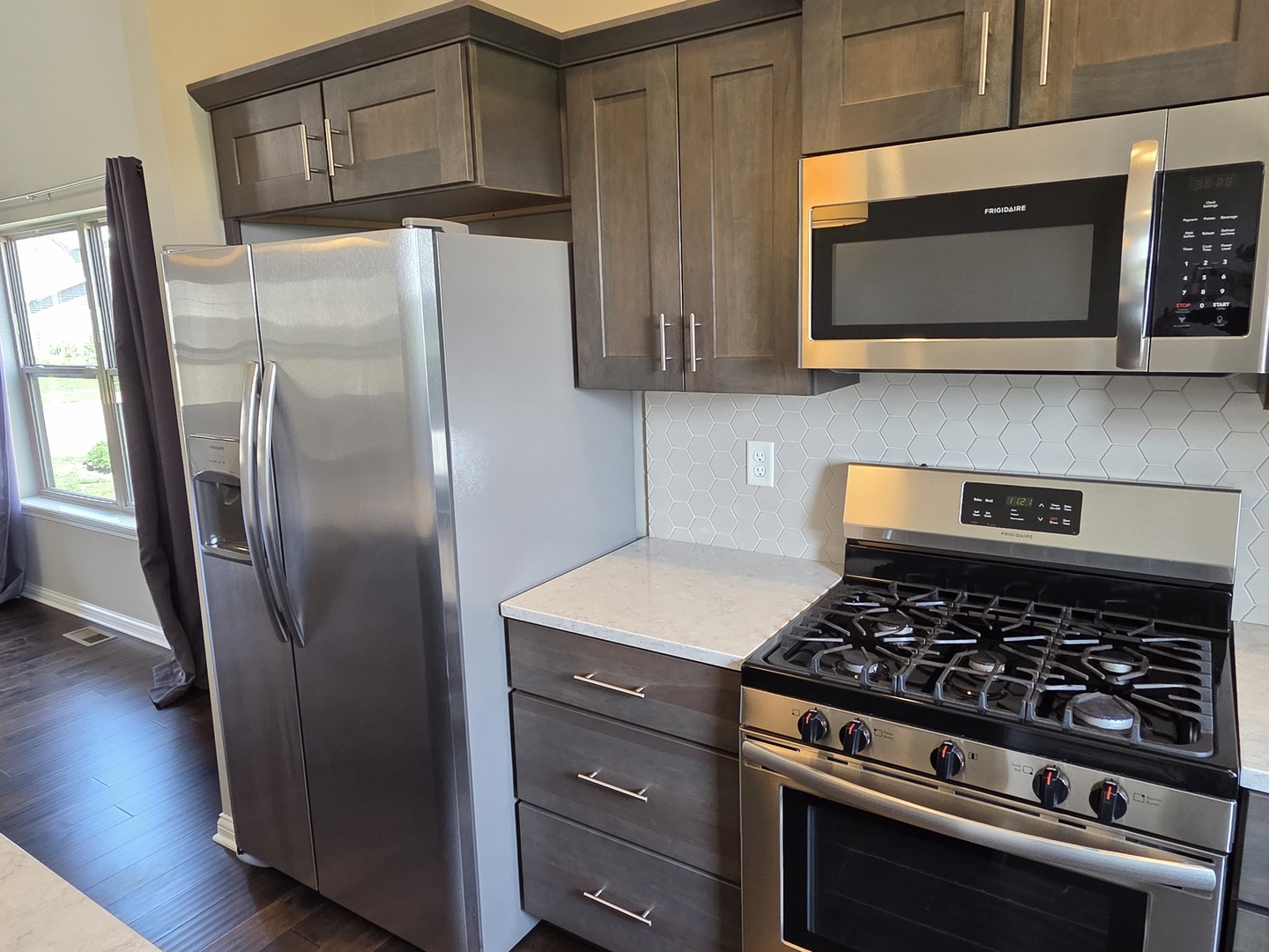 1036 Stags Leap Road Normal, IL 61761 - Photo 10 of 43 a kitchen with stainless steel appliances granite countertop a stove a refrigerator and a microwave