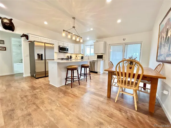 a view of a dining room with furniture and wooden floor