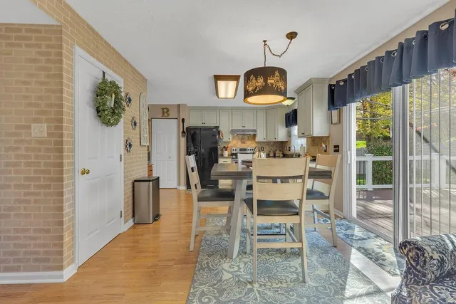 a view of a dining room with furniture window and front door
